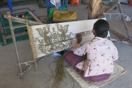 Tying a set of threads (known as the futus resist dye technique) is the most intricate and time-consuming aspect of weaving tais. The thread is first wound onto a bamboo frame. Sections forming the motif are tied off with palm leaf strips and the cloth is then submerged in dye. The ties block the dye so the tied threads retain their original colour. After the ties are carefully cut away, the threads are woven into the tais to reveal the motif.