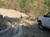 Next morning, a road worker guides us down the treacherous track to the Marobo hot springs.